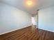 Clean, bright bedroom with wood floors, light blue walls, and an open doorway at 7147 Yacht Basin Ave # 115, Orlando, FL 32835