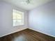 Bedroom featuring wood-look floors and a window with blinds at 7147 Yacht Basin Ave # 115, Orlando, FL 32835
