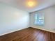 Cozy bedroom with wood floors, window with blinds, and neutral wall color at 7147 Yacht Basin Ave # 115, Orlando, FL 32835