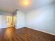 Bedroom featuring wood floors, blue walls, and a view into an ensuite bathroom at 7147 Yacht Basin Ave # 115, Orlando, FL 32835