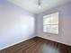 Bedroom featuring wood-look floors and a window at 7147 Yacht Basin Ave # 115, Orlando, FL 32835