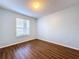 Inviting bedroom with hardwood floors, window with blinds, and neutral decor at 7147 Yacht Basin Ave # 115, Orlando, FL 32835