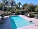 Refreshing community pool with lounge chairs and lush landscaping is perfect for relaxation at 7147 Yacht Basin Ave # 115, Orlando, FL 32835