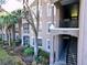 Exterior view of building 7147 with lush landscape and mature trees at 7147 Yacht Basin Ave # 115, Orlando, FL 32835