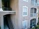 Exterior view of building 7147 shows stairwell access and neutral paint at 7147 Yacht Basin Ave # 115, Orlando, FL 32835