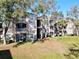 Exterior of a condominium building featuring private balconies and mature landscaping in a community at 7147 Yacht Basin Ave # 115, Orlando, FL 32835