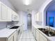 Bright kitchen with white cabinets, appliances, and tile floors at 7147 Yacht Basin Ave # 115, Orlando, FL 32835