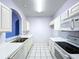 Kitchen with white cabinets, stainless steel appliances, and tile flooring at 7147 Yacht Basin Ave # 115, Orlando, FL 32835