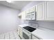 Kitchen with white cabinets and modern appliances at 7147 Yacht Basin Ave # 115, Orlando, FL 32835