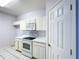 Kitchen with white appliances and countertops at 7147 Yacht Basin Ave # 115, Orlando, FL 32835
