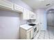 Clean kitchen features white cabinets, appliances, and tile flooring, ready for culinary adventures at 7147 Yacht Basin Ave # 115, Orlando, FL 32835