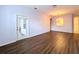 Living room with wood floors, glass door, and open layout at 7147 Yacht Basin Ave # 115, Orlando, FL 32835