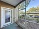 A screened patio with lush greenery, providing privacy and a relaxing outdoor space at 7147 Yacht Basin Ave # 115, Orlando, FL 32835