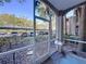 The screened porch has a view of the parking lot and mature landscaping at 7147 Yacht Basin Ave # 115, Orlando, FL 32835