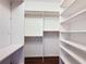 Large walk-in closet featuring a built-in organization system with shelves and hanging rods at 7147 Yacht Basin Ave # 115, Orlando, FL 32835