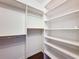 Bright walk-in closet with custom shelves and rods for optimal storage and organization at 7147 Yacht Basin Ave # 115, Orlando, FL 32835