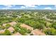 Scenic aerial view showcasing the property surrounded by mature trees and the nearby golf course at 7159 Cadiz Blvd, Orlando, FL 32819