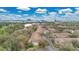 Aerial view of residential townhomes with lush greenery, a vibrant skyline in the background at 7159 Cadiz Blvd, Orlando, FL 32819