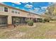 Rear exterior view of home highlighting a screened lanai and well-manicured landscaping at 7159 Cadiz Blvd, Orlando, FL 32819