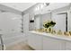 A well-lit bathroom features double sinks, a soaking tub, and white cabinets for a clean, modern look at 7159 Cadiz Blvd, Orlando, FL 32819