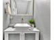 Stylish bathroom sink with modern faucet, decorative accents, and a coordinated mirror at 7159 Cadiz Blvd, Orlando, FL 32819