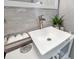 Modern bathroom sink with a stylish faucet, decorative towels, and elegant tile backsplash at 7159 Cadiz Blvd, Orlando, FL 32819