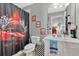 Fun bathroom with a car-themed shower curtain and vibrant race car decor at 7159 Cadiz Blvd, Orlando, FL 32819