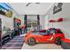 A vibrant bedroom with a race car bed, a gaming setup, and fun decorative accents at 7159 Cadiz Blvd, Orlando, FL 32819