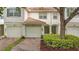 Charming townhome with brick driveway, one-car garage, well maintained landscaping, and tile roof at 7159 Cadiz Blvd, Orlando, FL 32819