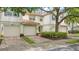Charming townhome with brick driveway, one-car garage, well maintained landscaping, and tile roof at 7159 Cadiz Blvd, Orlando, FL 32819