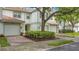 Charming townhome with brick driveway, one-car garage, well maintained landscaping, and tile roof at 7159 Cadiz Blvd, Orlando, FL 32819