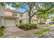 Charming townhome with brick driveway, one-car garage, well maintained landscaping, and tile roof at 7159 Cadiz Blvd, Orlando, FL 32819