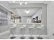 Kitchen featuring stainless steel appliances, white cabinets, and barstool seating at 7159 Cadiz Blvd, Orlando, FL 32819