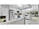 Bright kitchen featuring stainless steel appliances, white cabinets, and marble countertops at 7159 Cadiz Blvd, Orlando, FL 32819