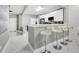 View of the sleek, modern white kitchen with stainless steel appliances and marble flooring at 7159 Cadiz Blvd, Orlando, FL 32819