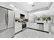 Open kitchen with stainless steel appliances, white cabinets, and an open to the dining area at 7159 Cadiz Blvd, Orlando, FL 32819