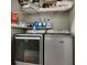 Well-organized laundry room featuring a modern washer and dryer set with storage shelves above at 7159 Cadiz Blvd, Orlando, FL 32819