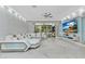 Bright living room features a white sectional sofa, textured wall, and patio doors at 7159 Cadiz Blvd, Orlando, FL 32819