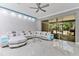 Bright and modern living room featuring a sectional sofa, marble floors, and natural light at 7159 Cadiz Blvd, Orlando, FL 32819
