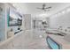 Open concept living room with a large tv, unique textured wall, and marble floors at 7159 Cadiz Blvd, Orlando, FL 32819