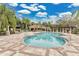 Community pool area featuring a lounging space, mature landscaping, and clear blue water for recreation at 7159 Cadiz Blvd, Orlando, FL 32819