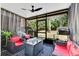 Inviting screened porch featuring comfortable seating, a fire pit table, and a relaxing outdoor atmosphere at 7159 Cadiz Blvd, Orlando, FL 32819