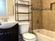 Well-maintained bathroom featuring tiled walls, a modern vanity, and a shower-tub combo at 7200 Ravenna Ave, Orlando, FL 32819