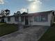 Curb view of a single story home with a grey concrete driveway and well-manicured lawn at 7200 Ravenna Ave, Orlando, FL 32819