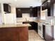 Updated kitchen with granite countertops, white appliances, dark cabinetry and tiled backsplash at 7200 Ravenna Ave, Orlando, FL 32819