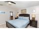 Cozy bedroom with a queen-size bed, nightstands, and soft blue bedding at 7952 Heritage Entrance Blvd, Kissimmee, FL 34747