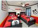 Themed bedroom with twin beds, ceiling fan, and red and black decor at 7952 Heritage Entrance Blvd, Kissimmee, FL 34747