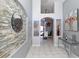Inviting foyer featuring decorative stone wall, tiled floors, and elegant decor at 7952 Heritage Entrance Blvd, Kissimmee, FL 34747