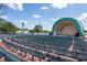 Outdoor venue with an empty stage, rows of seats, and a serene lake in the background at 807 E Pine St, Orlando, FL 32801