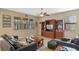 Inviting living room features a ceiling fan, built-in shelving, and large windows at 8137 Surf Bird St, Winter Garden, FL 34787